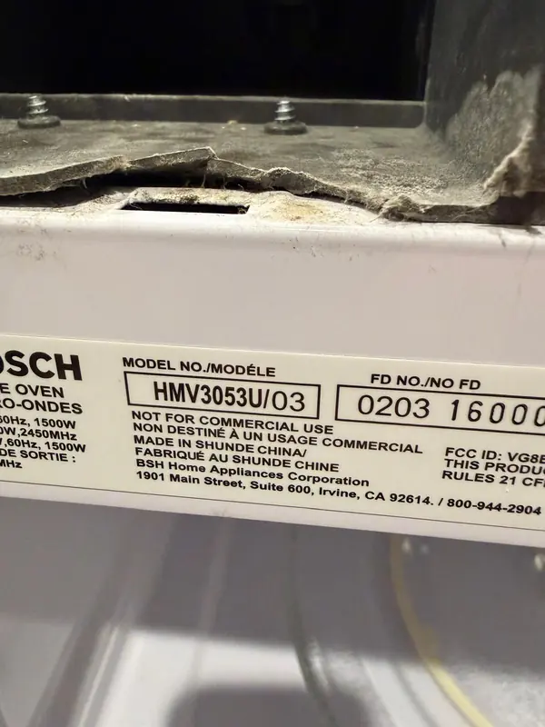 Model label on a Bosch over-the-range microwave reading HMV3053U/03, with its FD number
