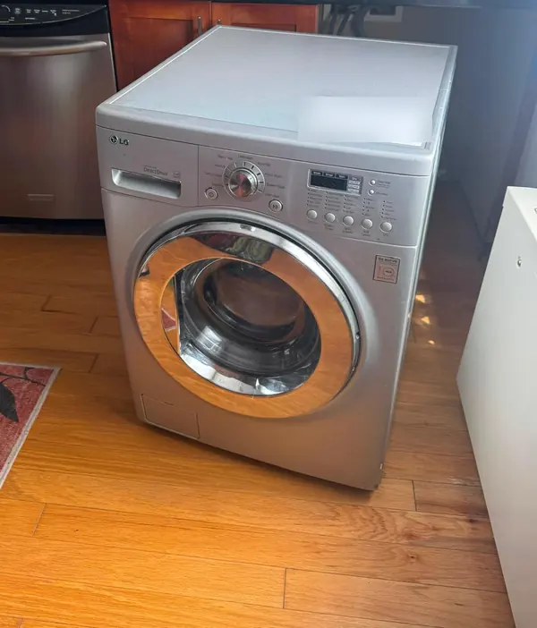 LG front-load washer-dryer combo pulled out in an apartment kitchen