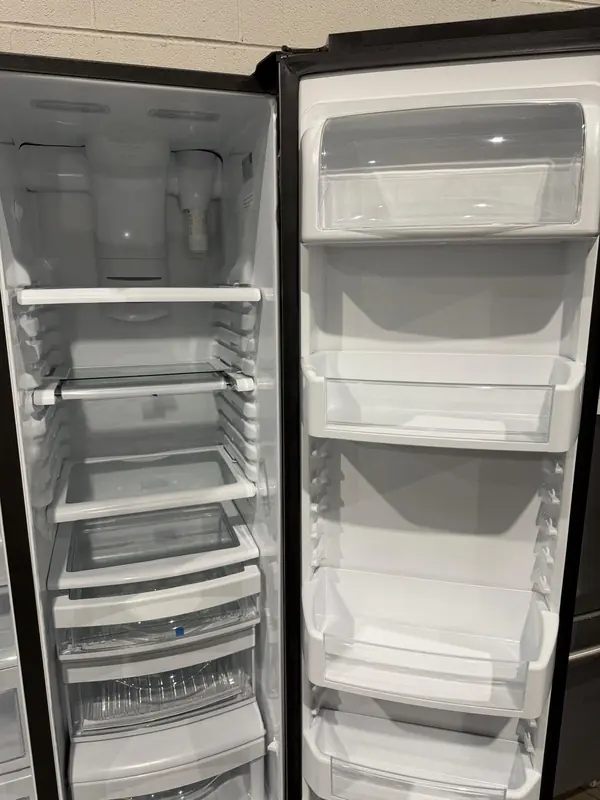 Fresh-food side of a side-by-side refrigerator with the water filter housing at the top