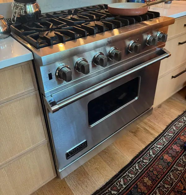 Viking professional-style gas range with continuous cast-iron grates in a home kitchen