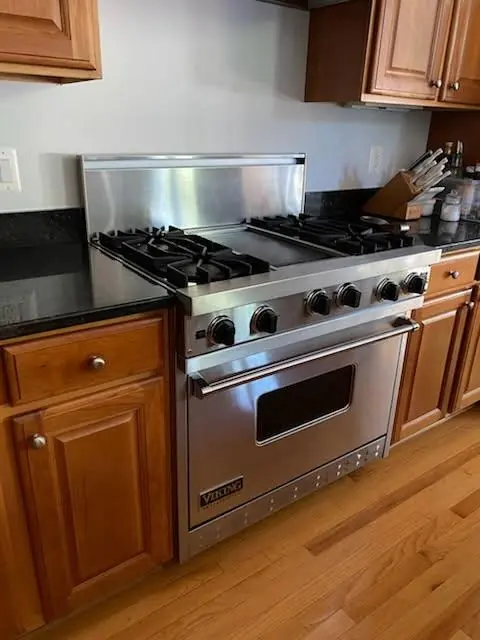 Viking professional-style gas range with four burners and a griddle